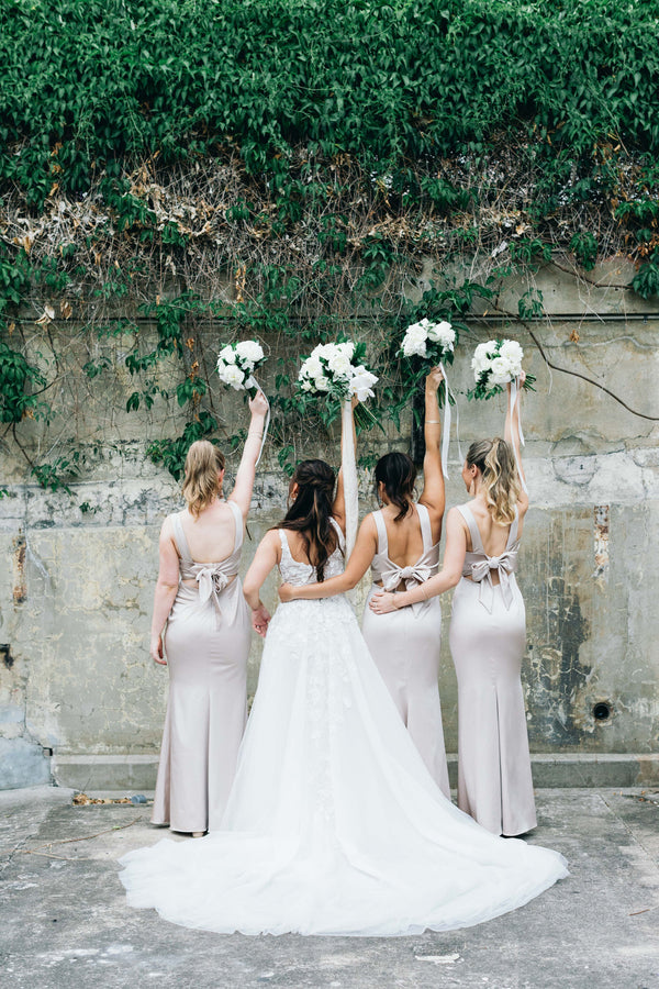 bride and bridesmaids in their dresses with bouquets