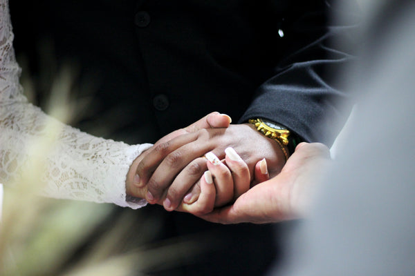 Couple holding hands at wedding ceremony