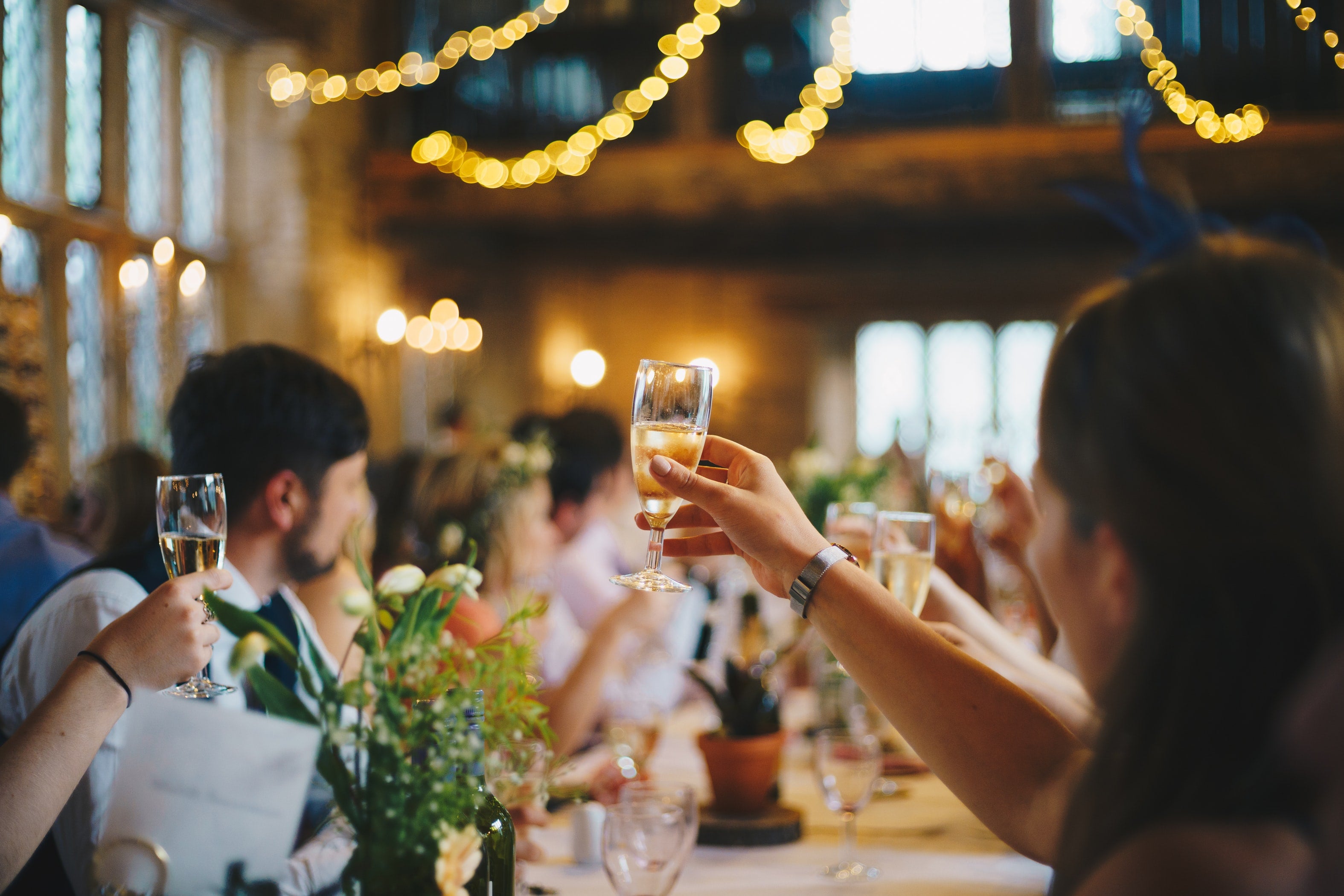 guests toasting with glasses of wine at wedding reception