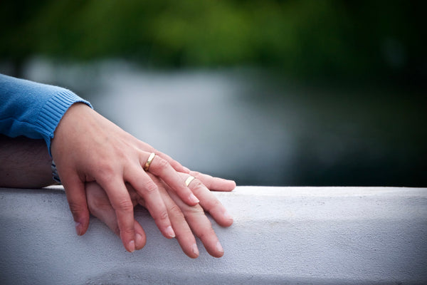 husband and wife's hands with wedding bands on
