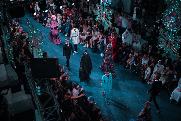 models on fashion runway surrounded by spectators