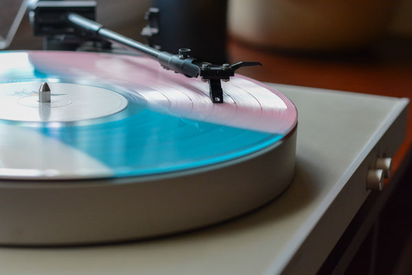 record player on table with vinyl music spinning
