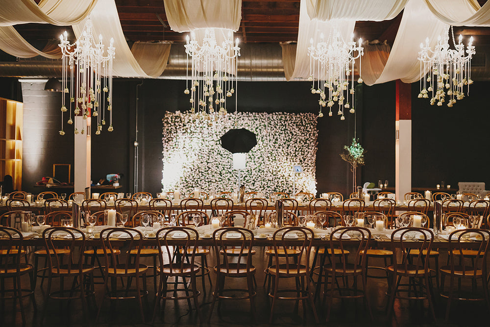 wedding reception venue with seating arrangements tables and chandeliers