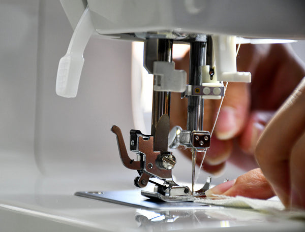 woman's hands on sewing machine