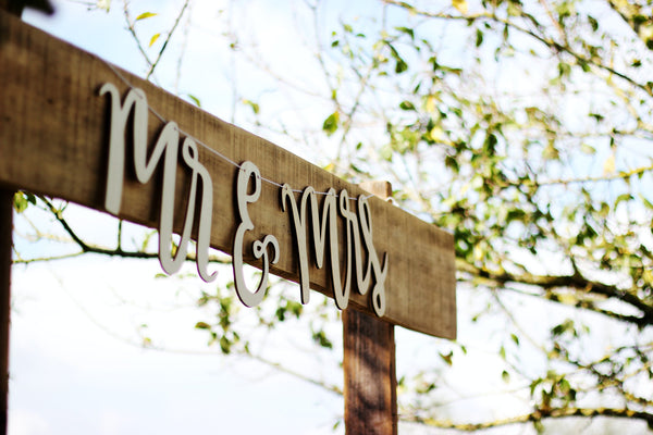 wooden sign with mr and mrs lettering hanging from it