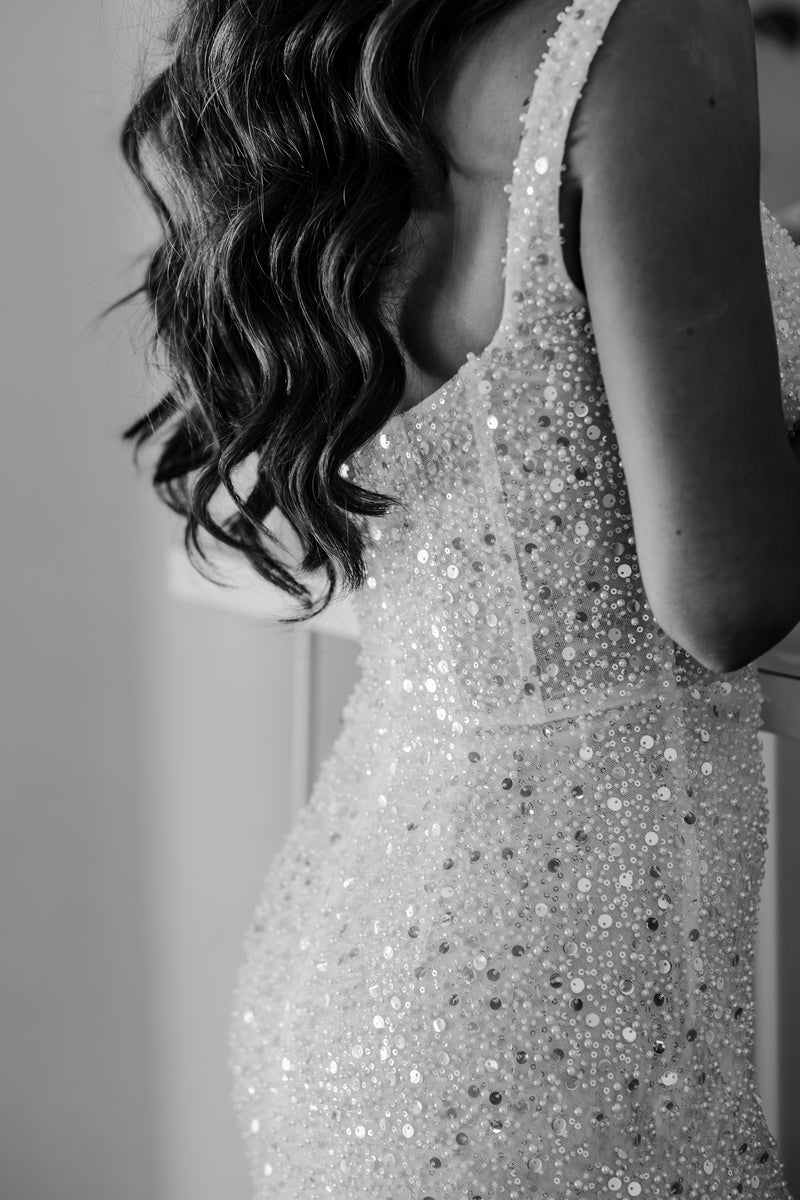 beaded sequin wedding gown on brides body with wavy hair