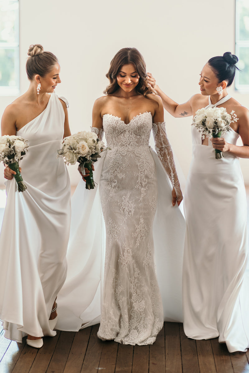 bride and bridesmaids in their wedding day attire holding flowers