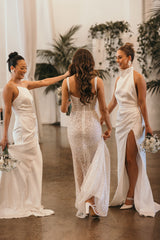 bride and bridesmaids in wedding attire holding bouquets at wedding