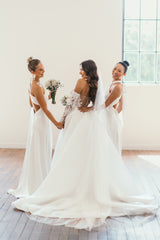 bride and two bridesmaids in their wedding day attire