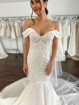 bride in beaded gown with black hair and white pearl earrings