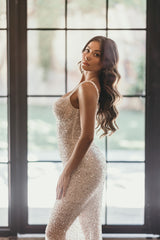 bride in beaded sequin wedding gown posing by black squared window
