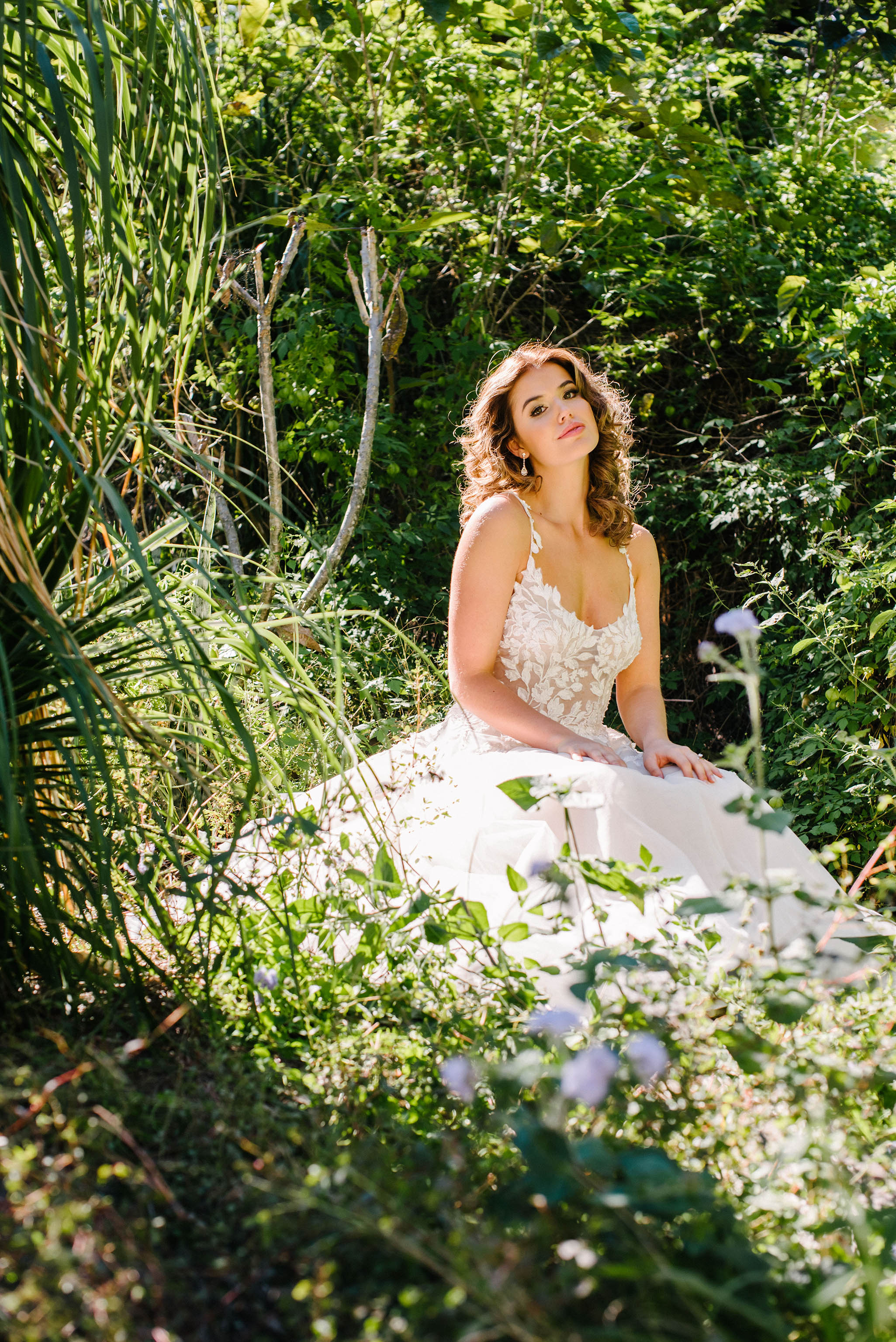 bride in floral lace wedding dress in greenery