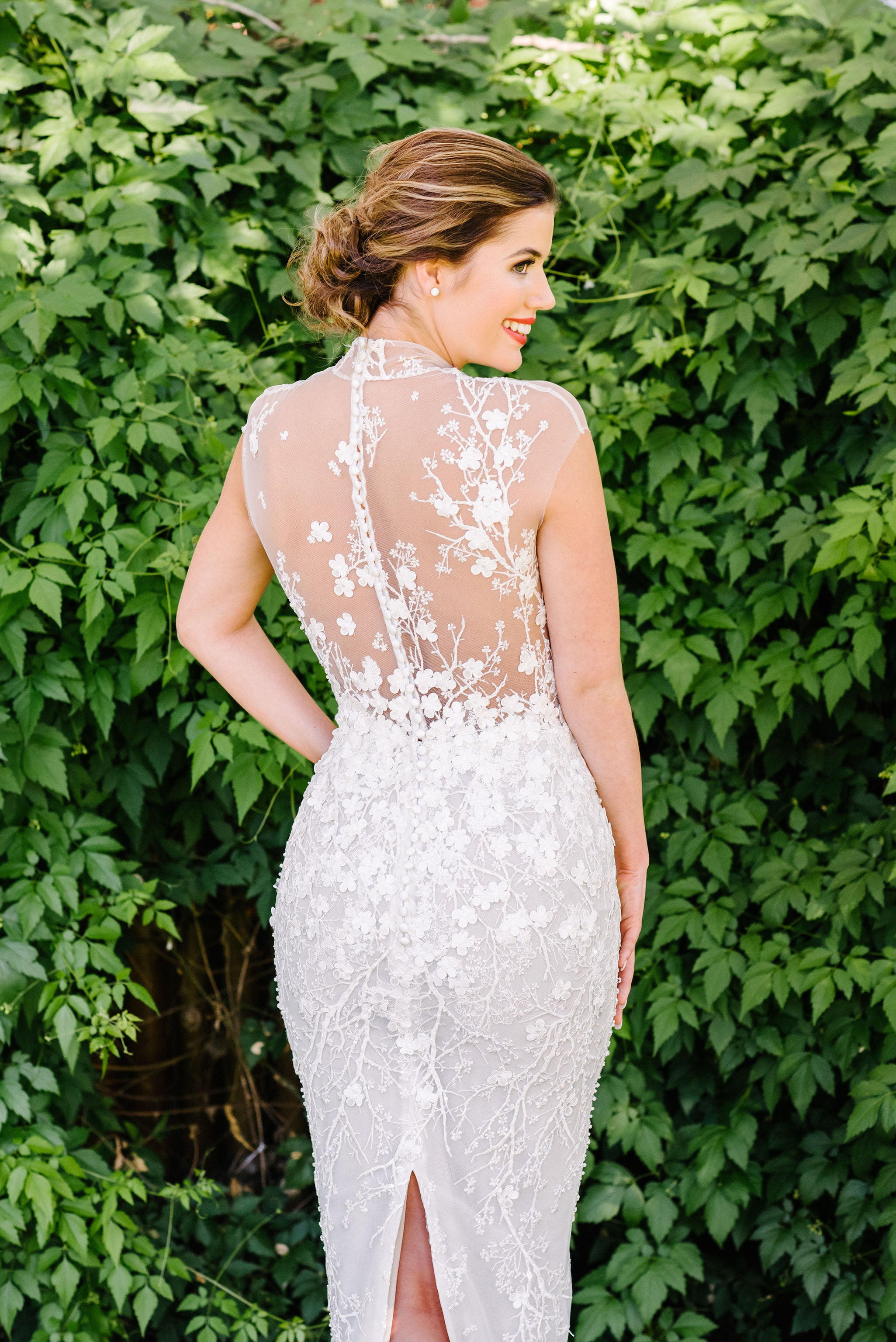 bride in illusion back cherry blossom lace wedding gown