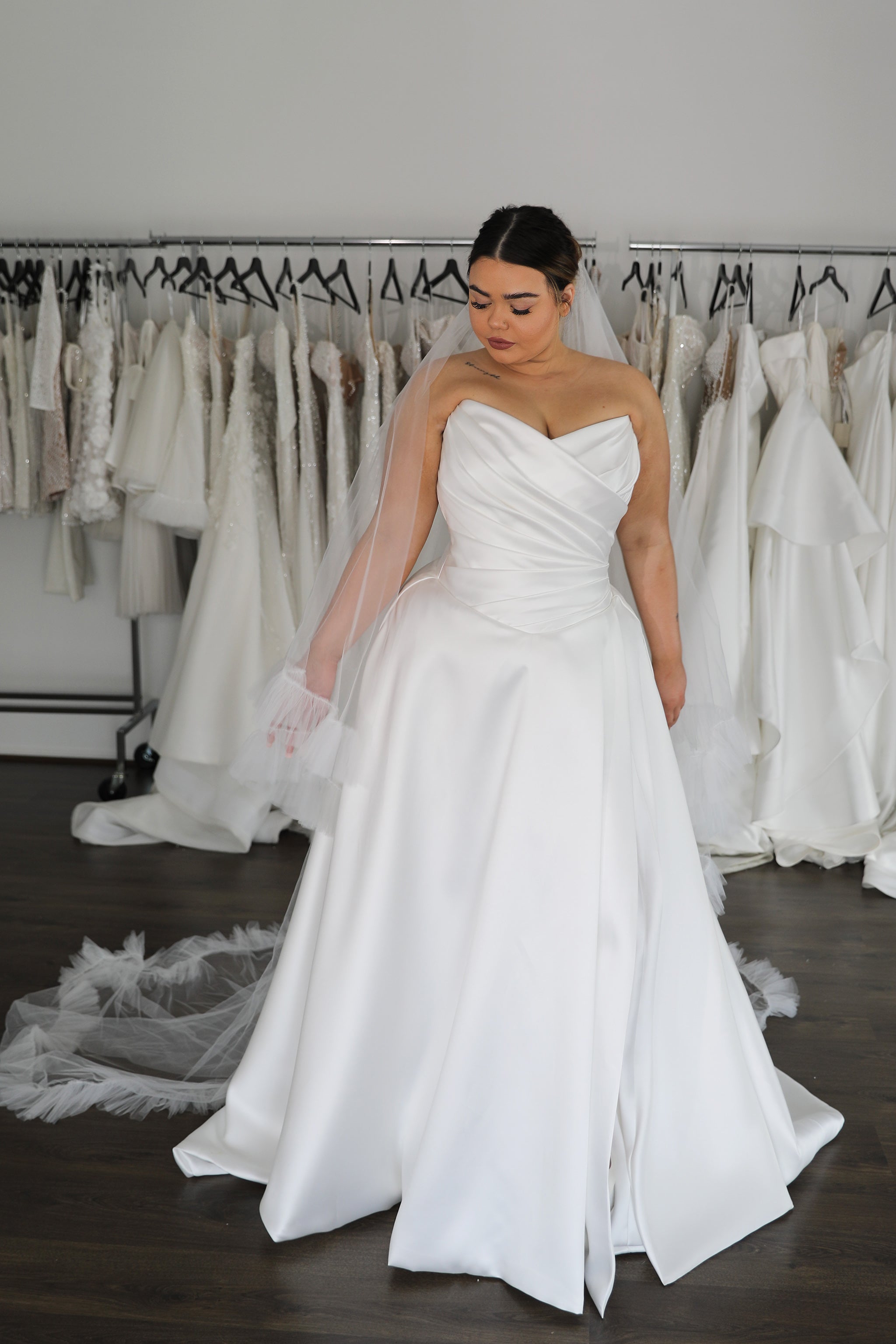 bride in mikado strapless wedding dress with tulle veil