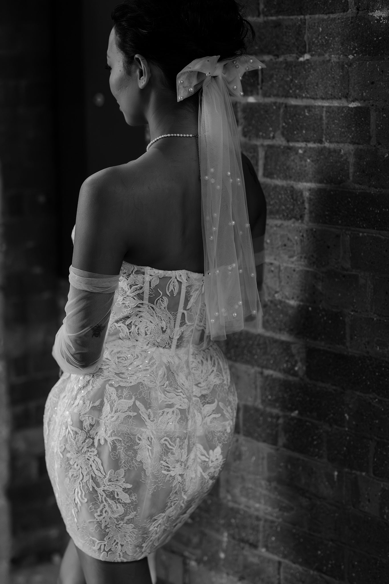 bride in mini wedding dress and pearl veil