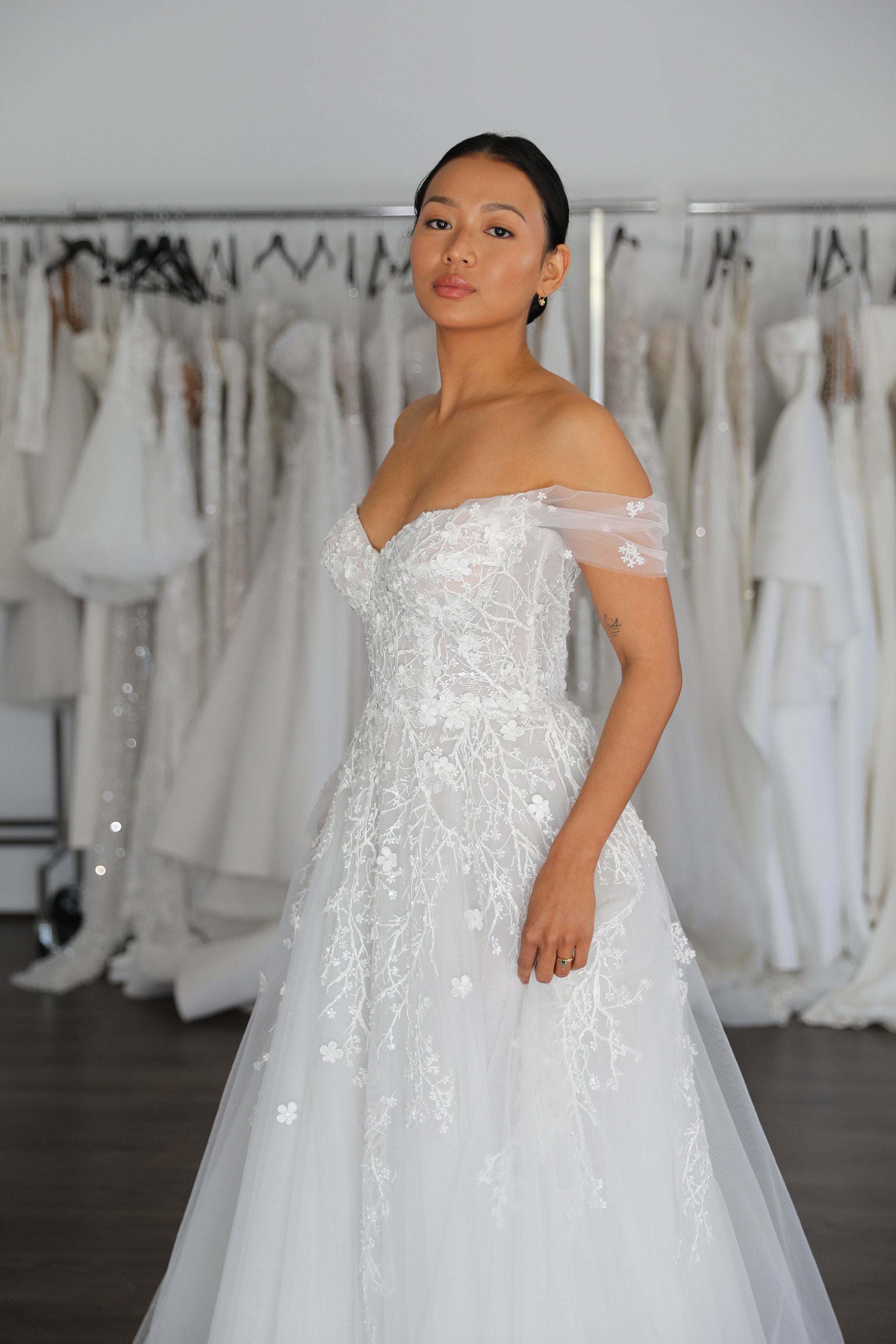 bride posing in floral cherry blossom lace wedding dress