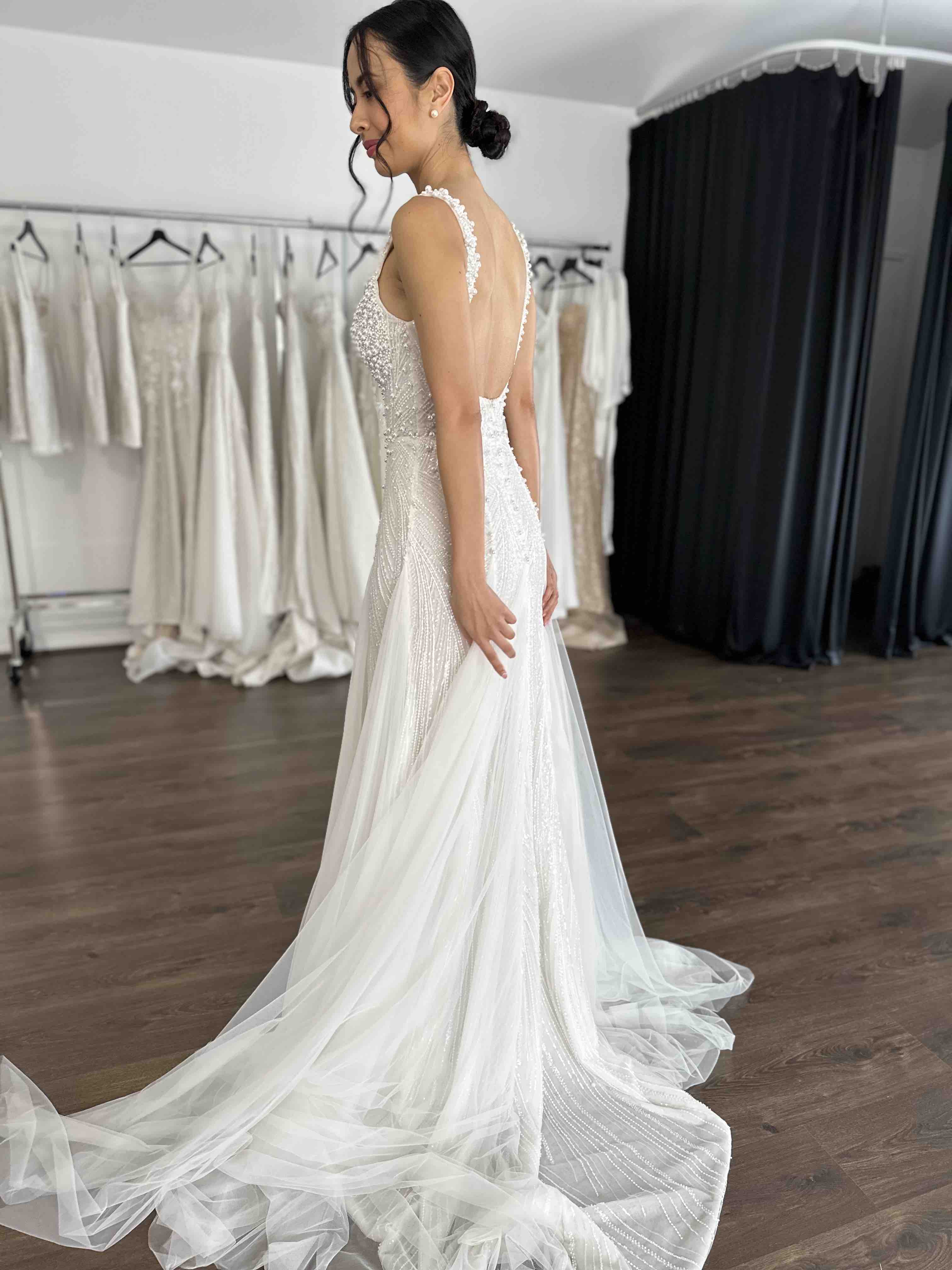 bride spinning around showroom in wedding gown