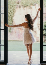 bride standing in doorway in lace bridal mini