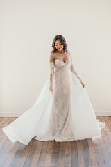 bride swaying her organza skirt wearing a beaded lace wedding dress