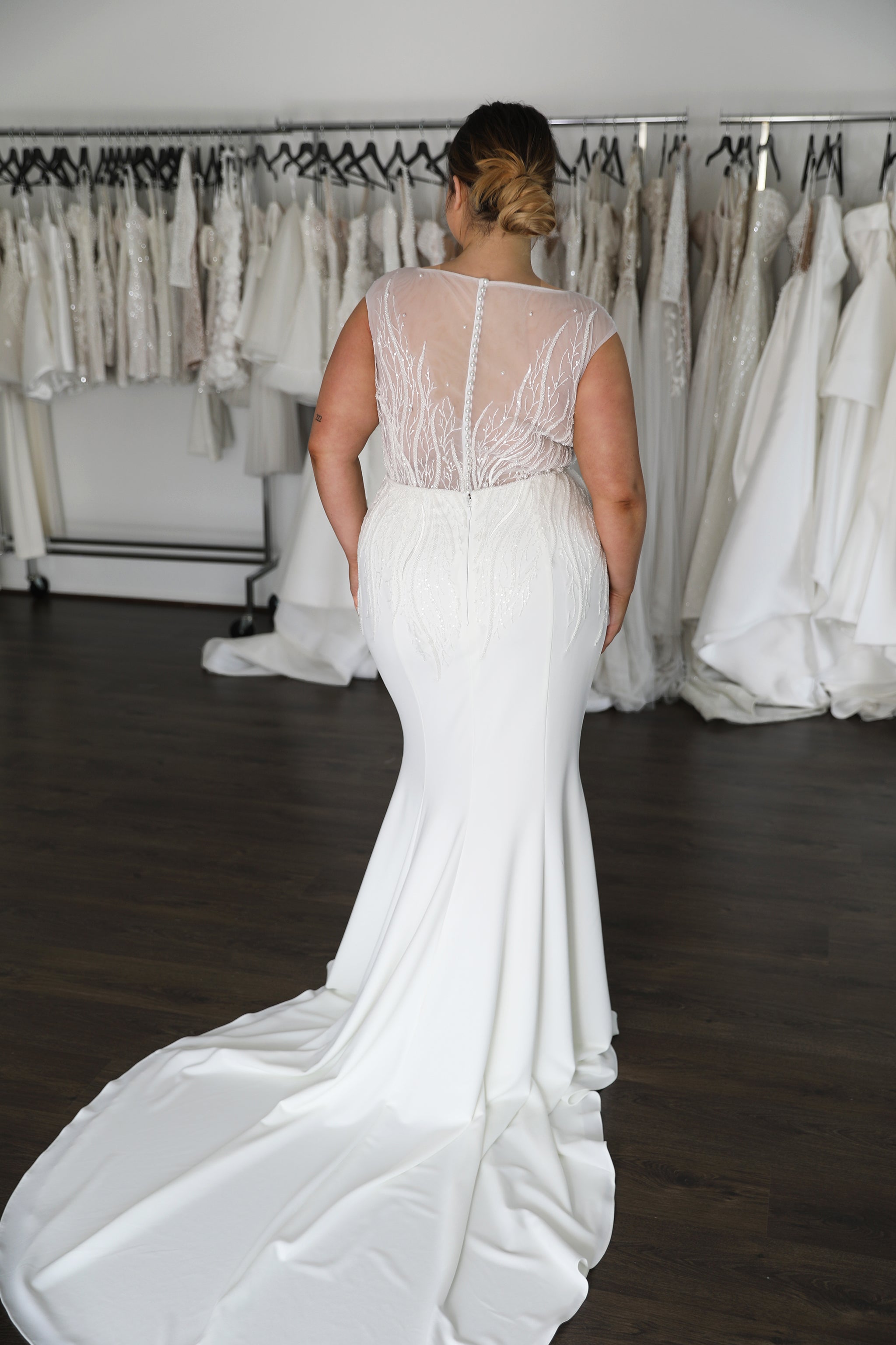 bride wearing crepe skirt with long train and illusion lace bodice