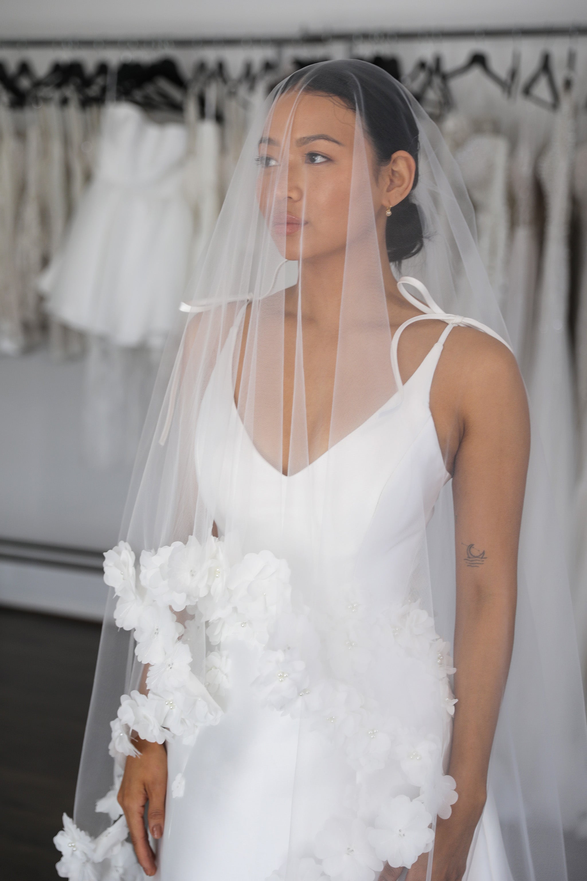 bride wearing flower embellished veil