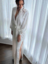 bride wearing long ivory wedding day robe with long sleeves