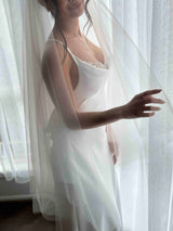 bride wearing slip dress with pearl inserts and Tulle wedding veil with blusher
