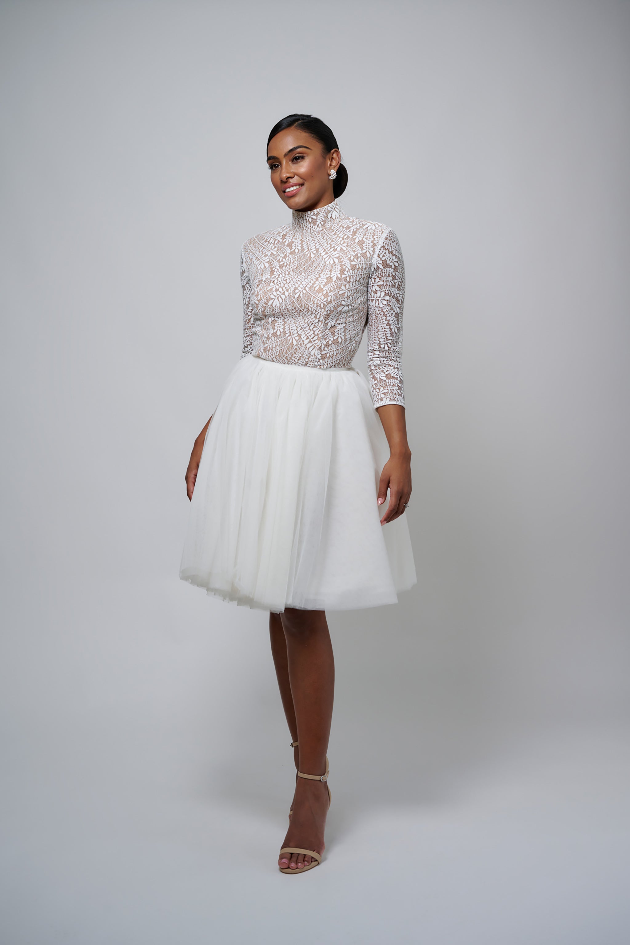 bride wearing tulle skirt and lace top with three quarter sleeves