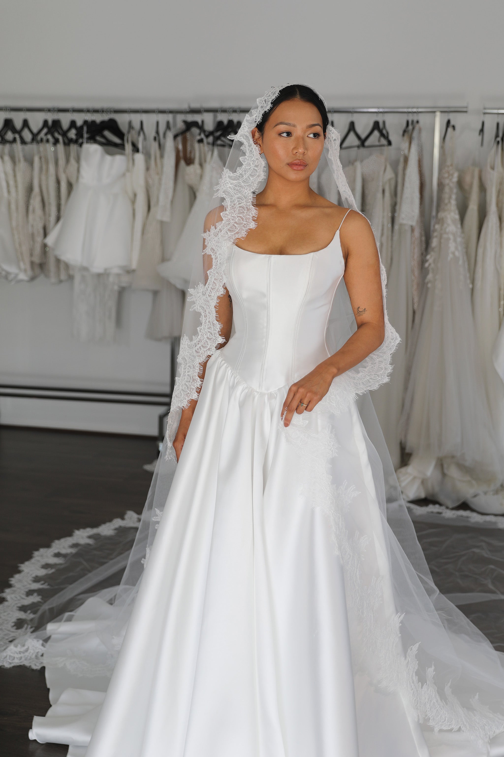 bride wearing veil and wedding dress with drop waist