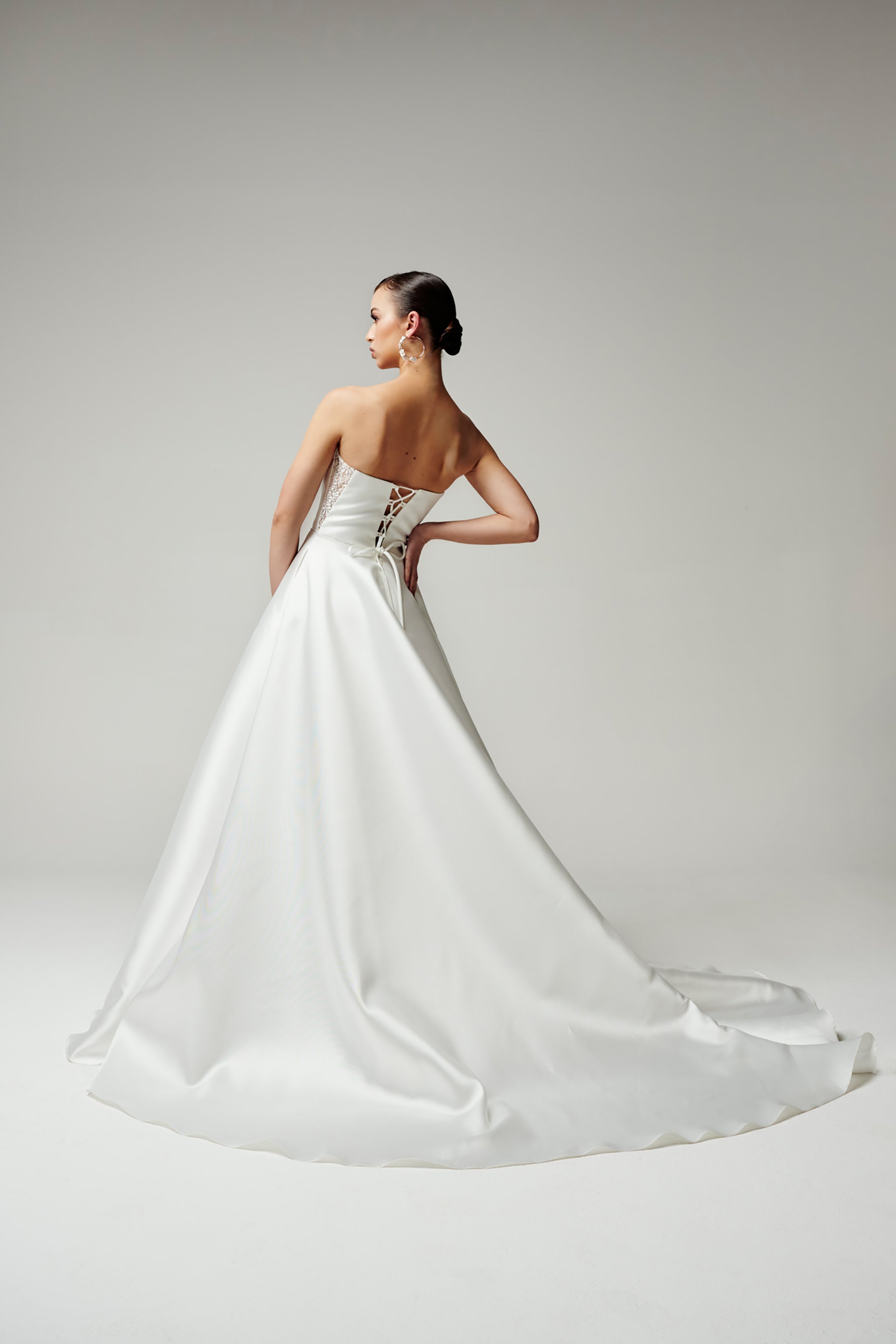 bride with long flowing train and strapless mikado wedding dress