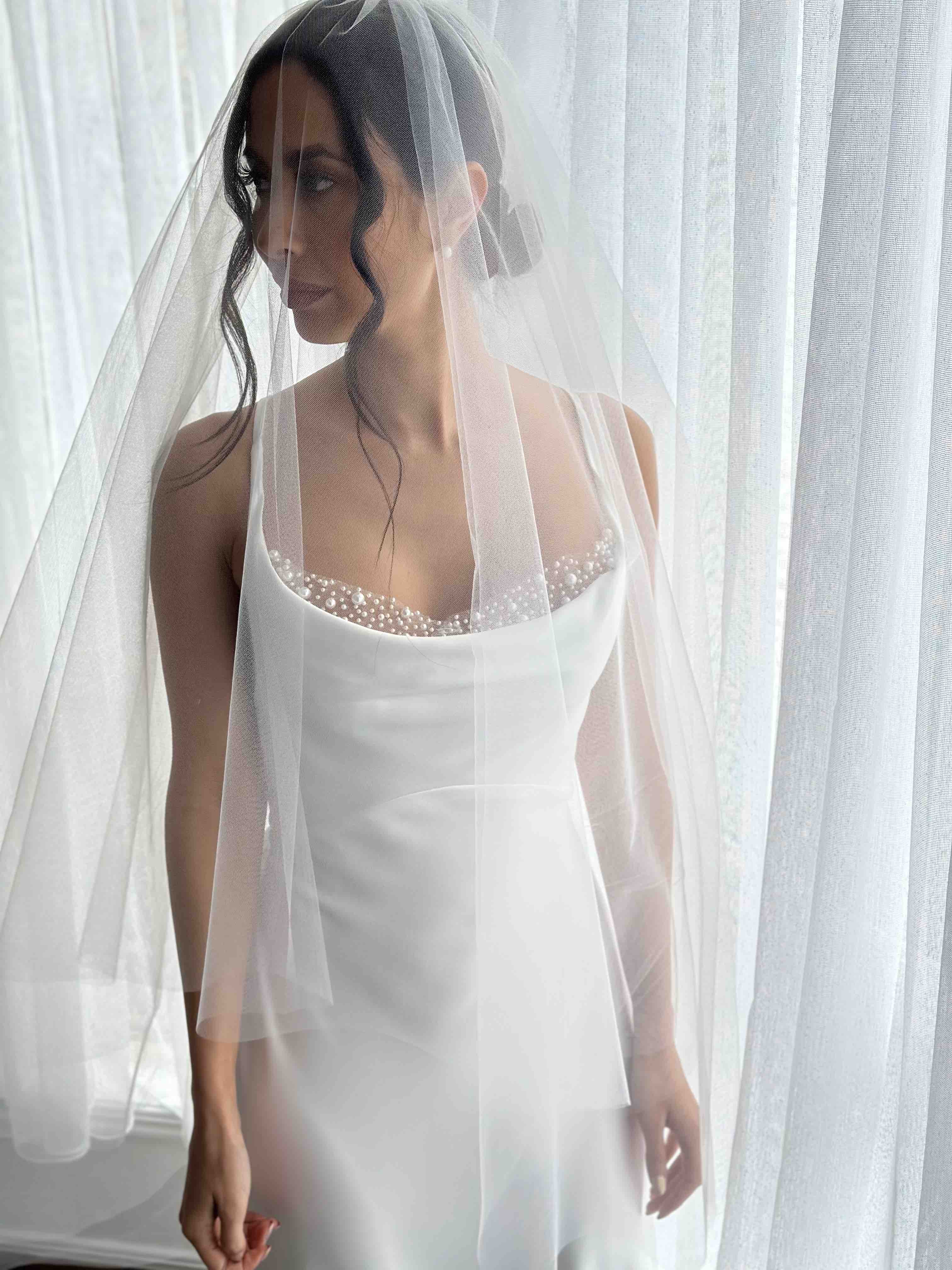 bride with short tulle veil over white bridal slip dress