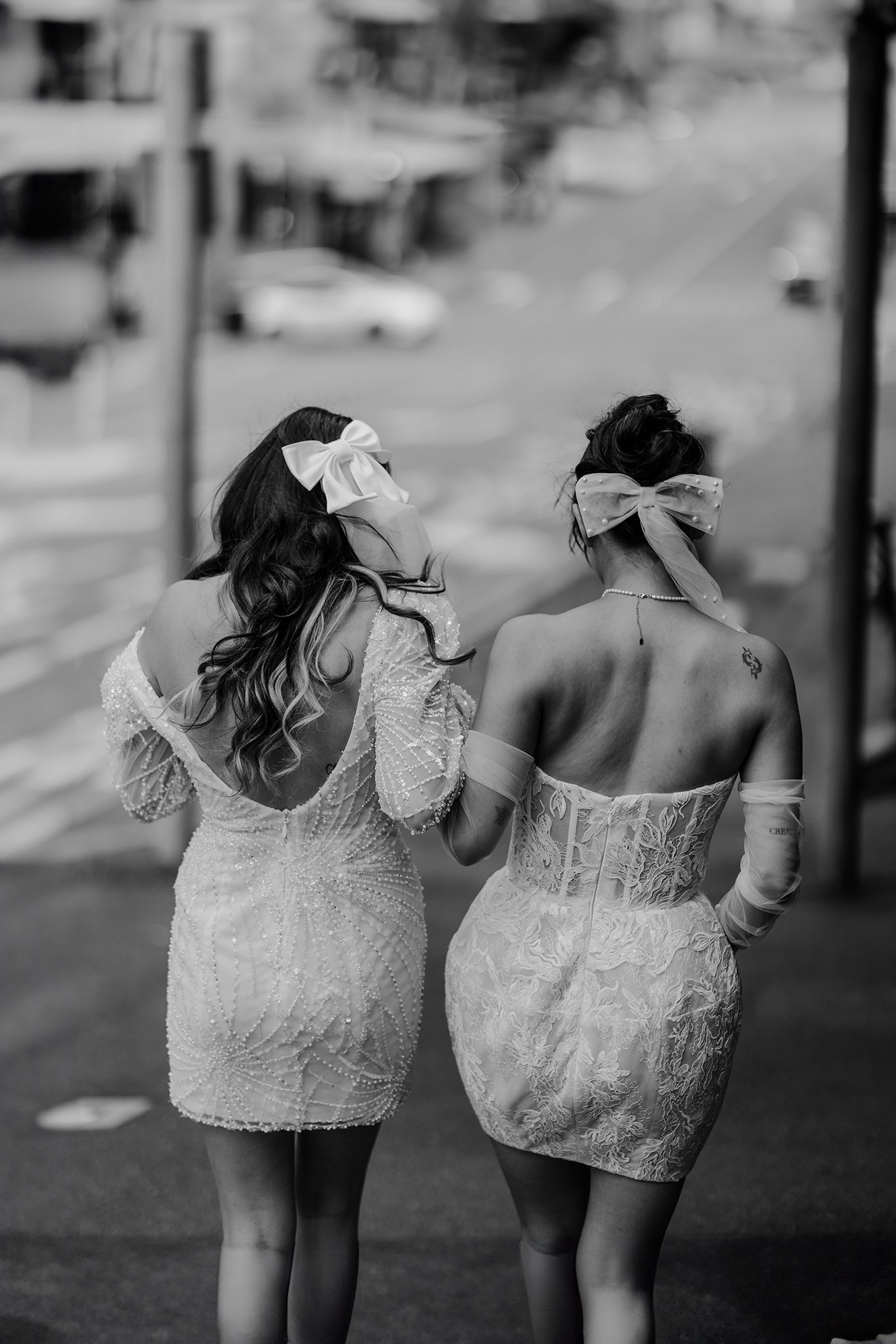 brides walking down city street in bridal mini dresses