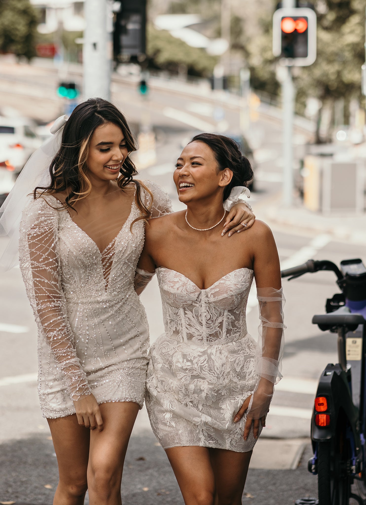 brides walking down city street in short wedding gowns