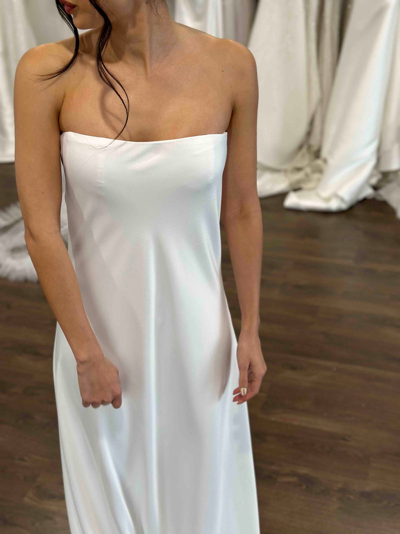 curved neckline strapless slip dress in white worn by bride