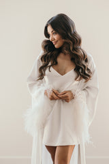 feathery robe and white slip dress on bride