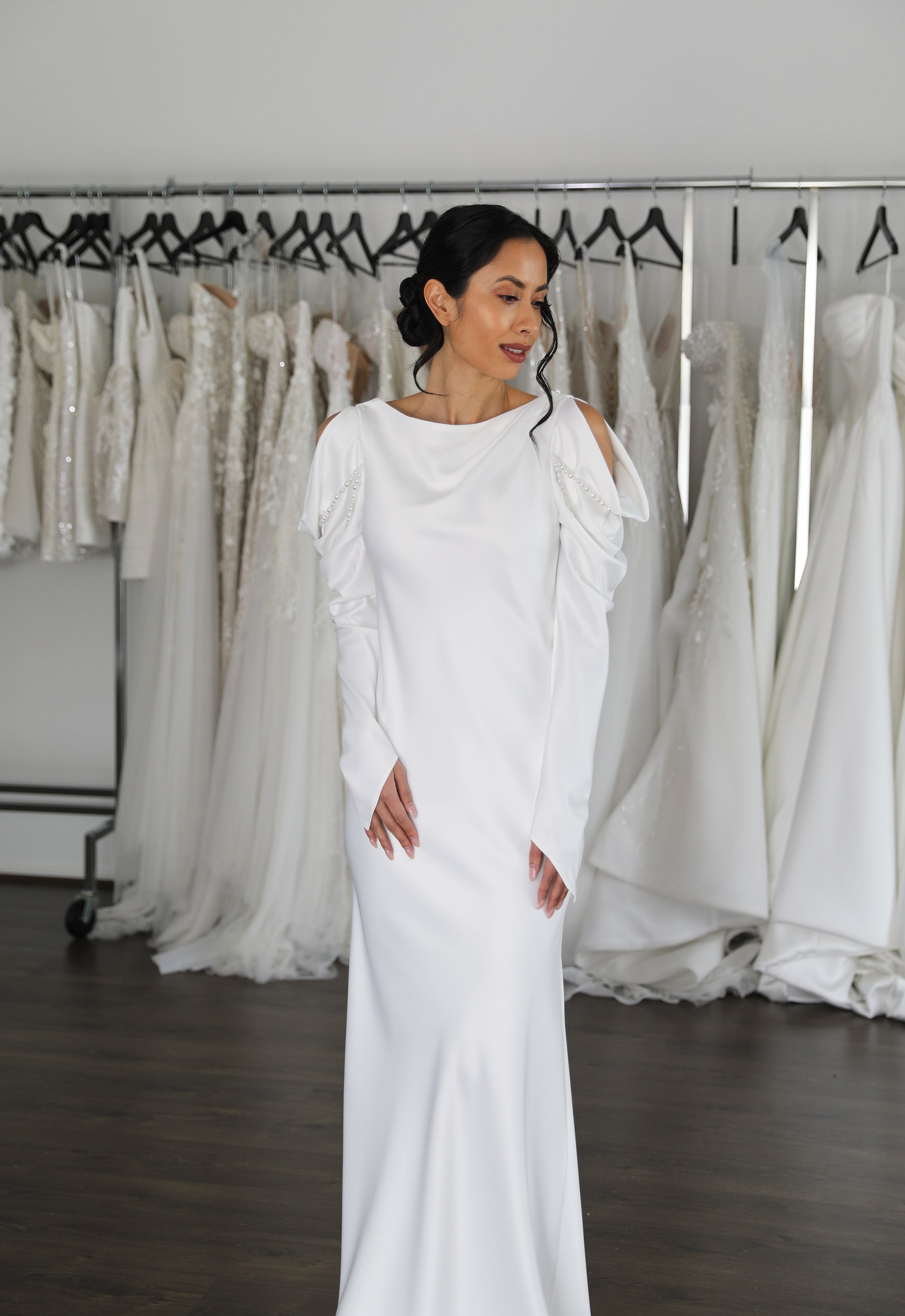 full length long sleeved wedding gown on bride