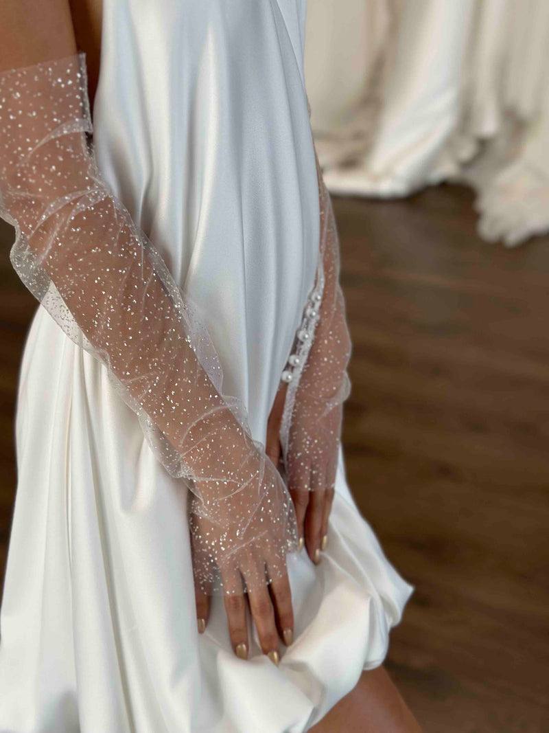 glittery tulle wedding long sleeve gloves on bride in white bubble hem mini dress