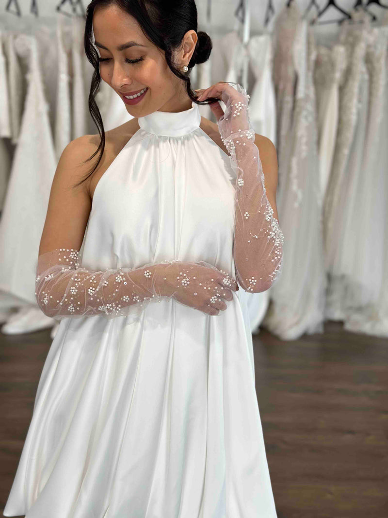 halter neck bubble hemmed wedding reception dress with tulle and pearl gloves