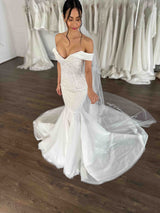 lady with black hair wearing off the shoulder wedding gown