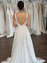 long flowing lace wedding dress with thin shoulder straps