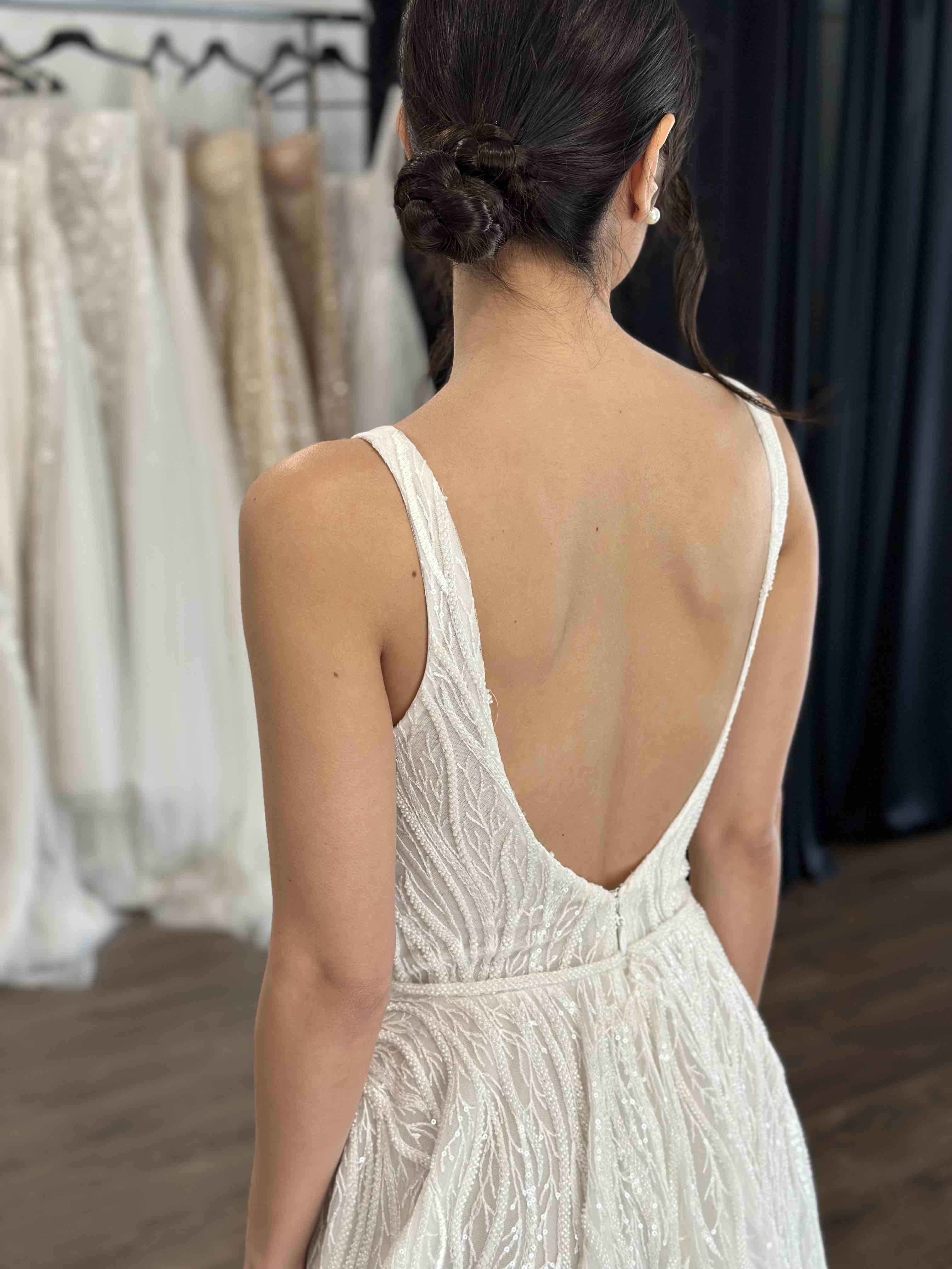 low back vine lace bridal gown on woman with black hair