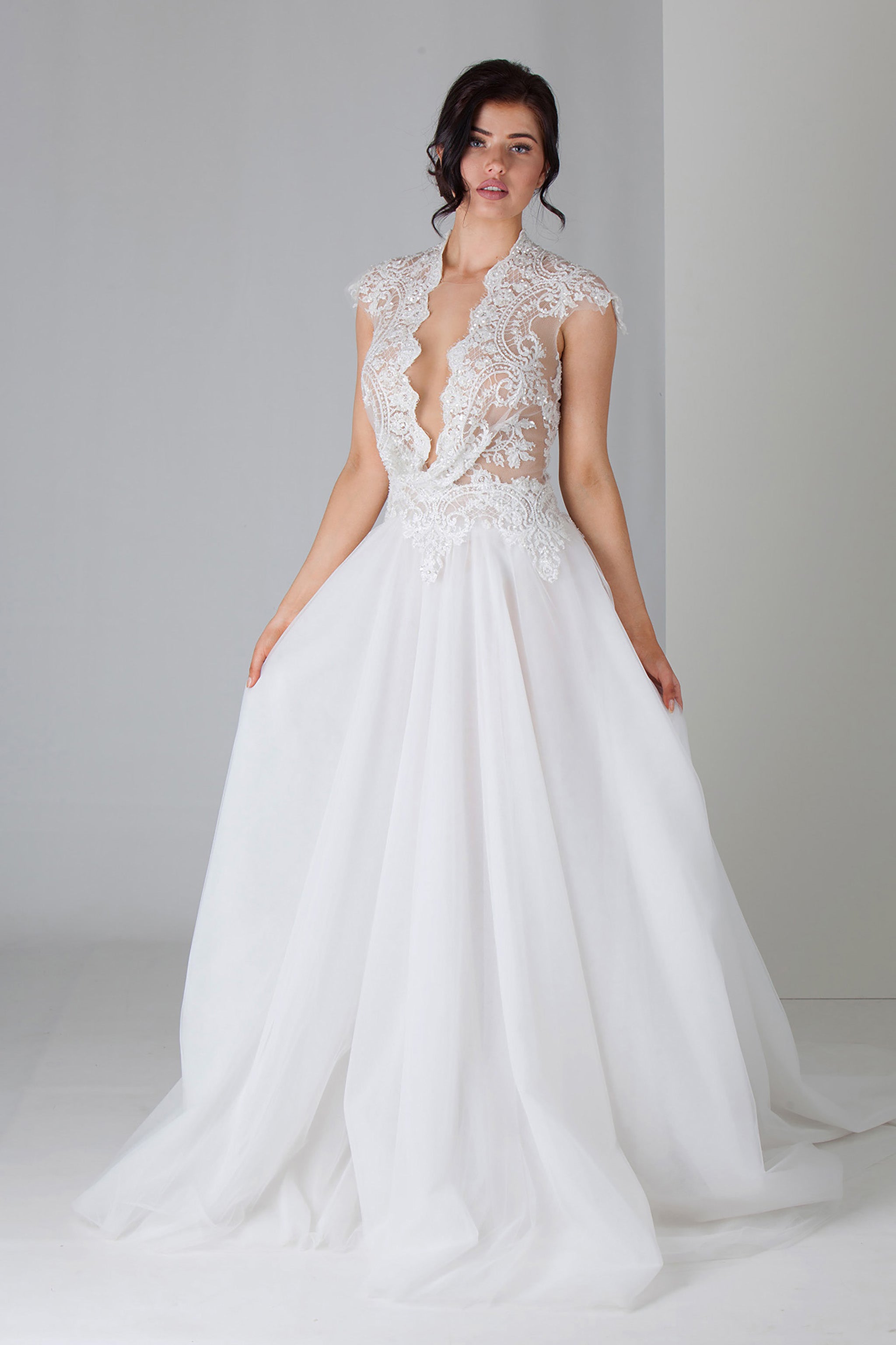 low cut v-neck wedding dress with flowing full skirt