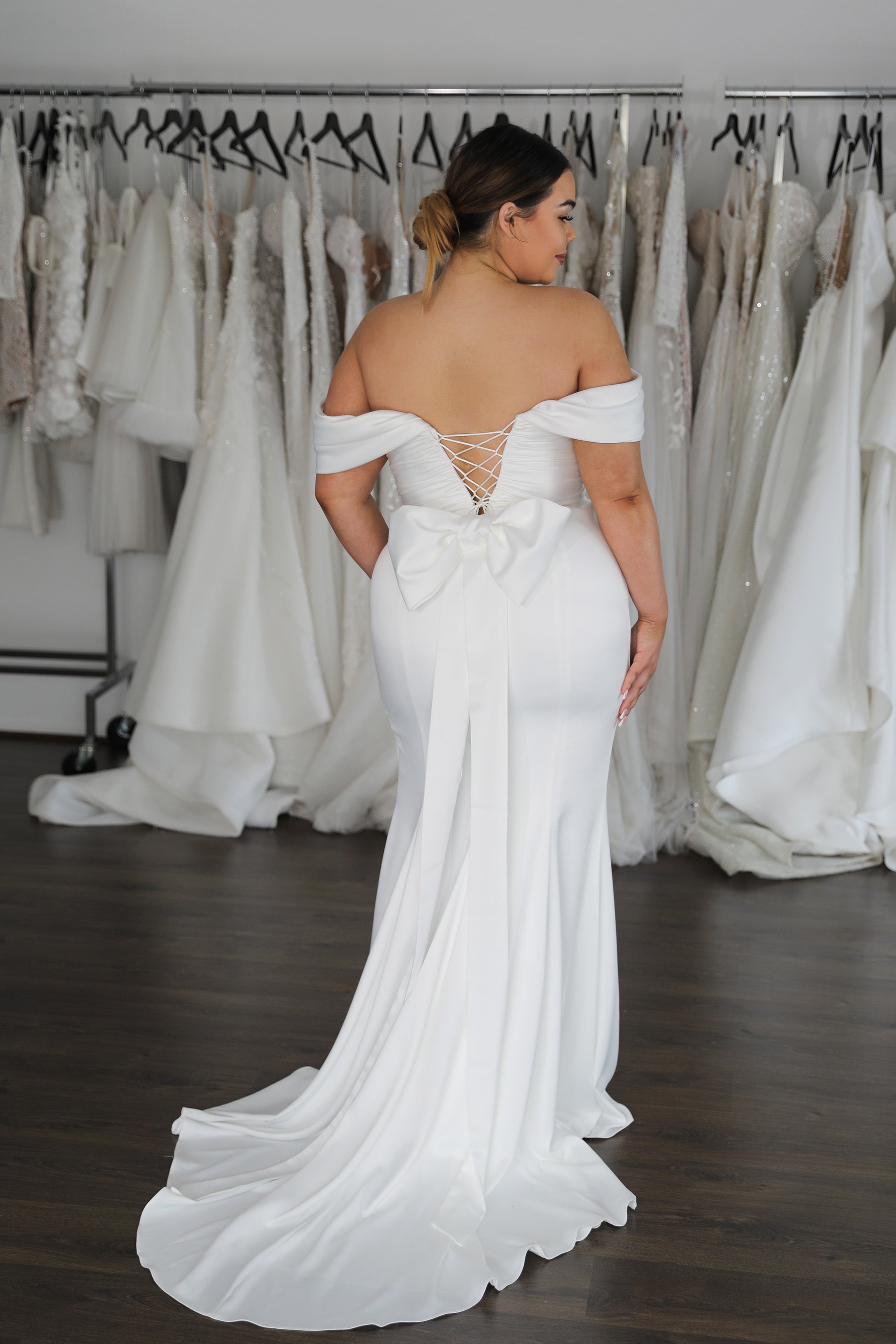 mermaid style wedding dress with lace up back and off the shoulder sleeves