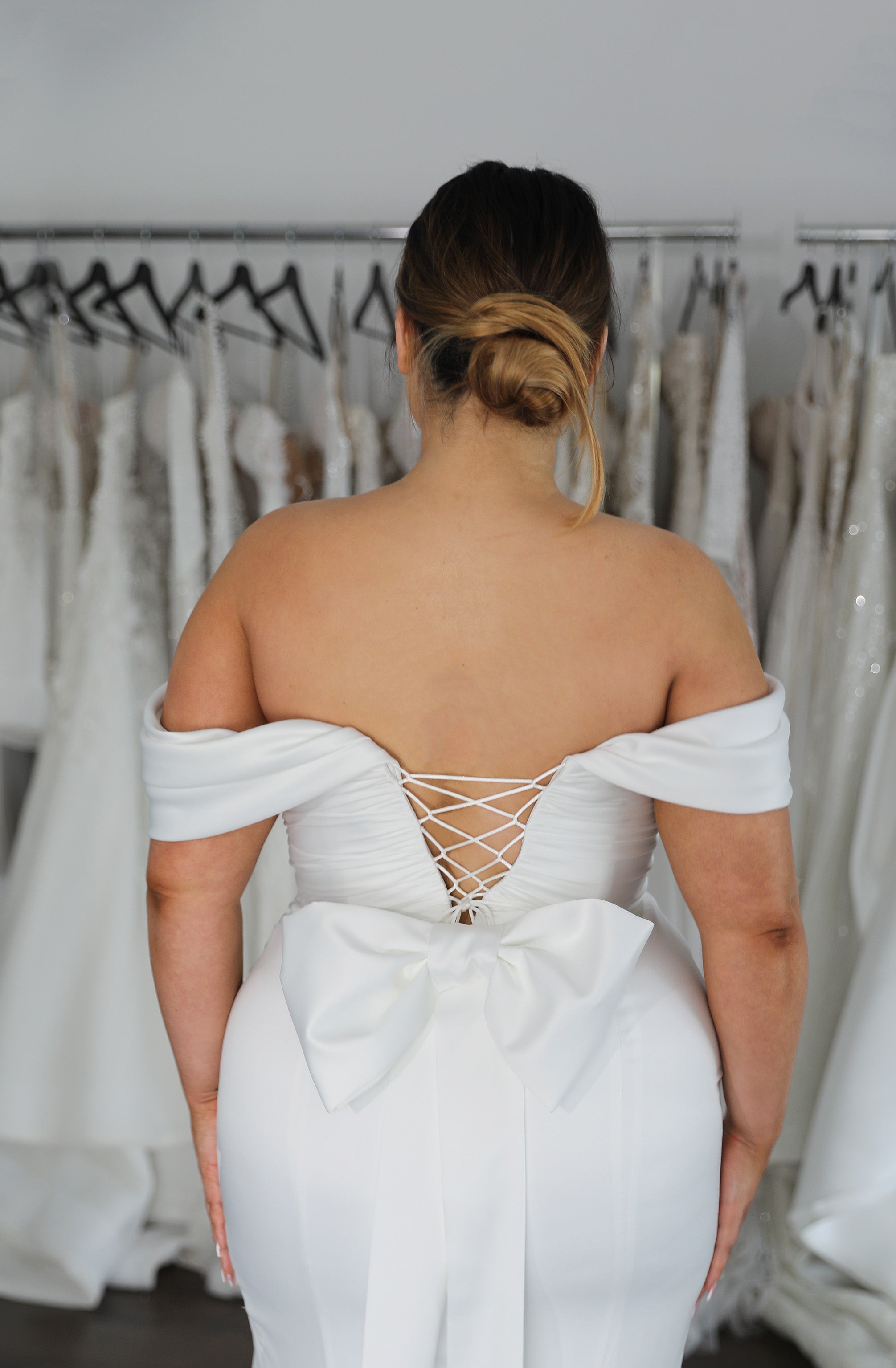 off the shoulder sleeved wedding dress with lace up back and bow