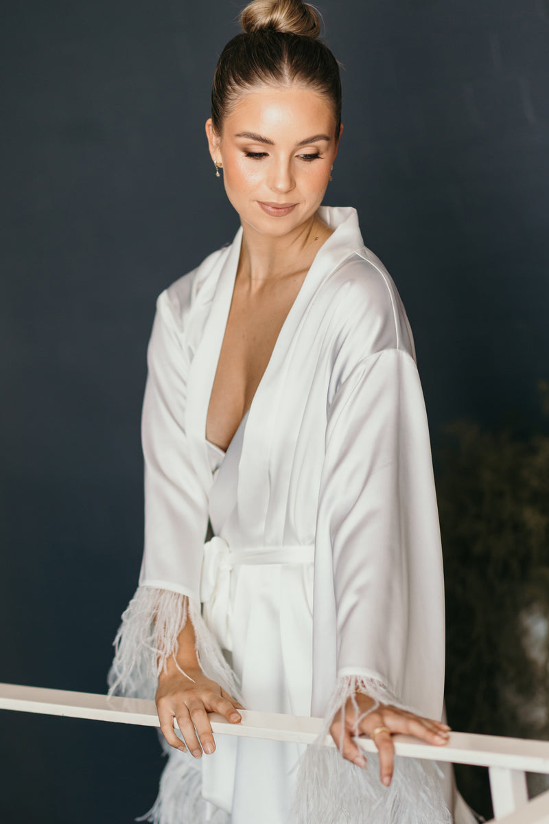 white bridal robe with feathery cuffs