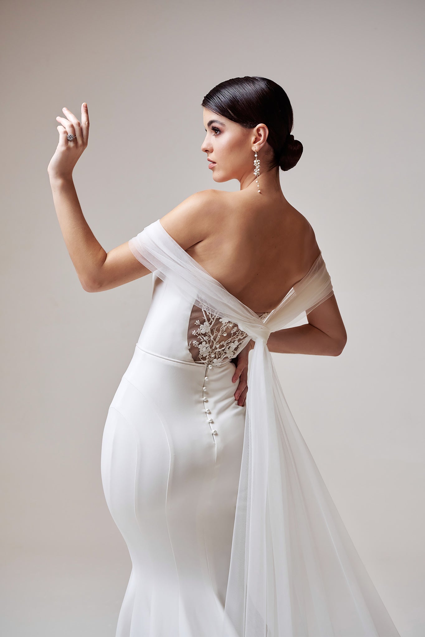 white fitted wedding dress with floral back cut outs
