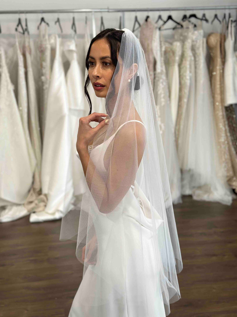 white slip dress and mid length tulle veil