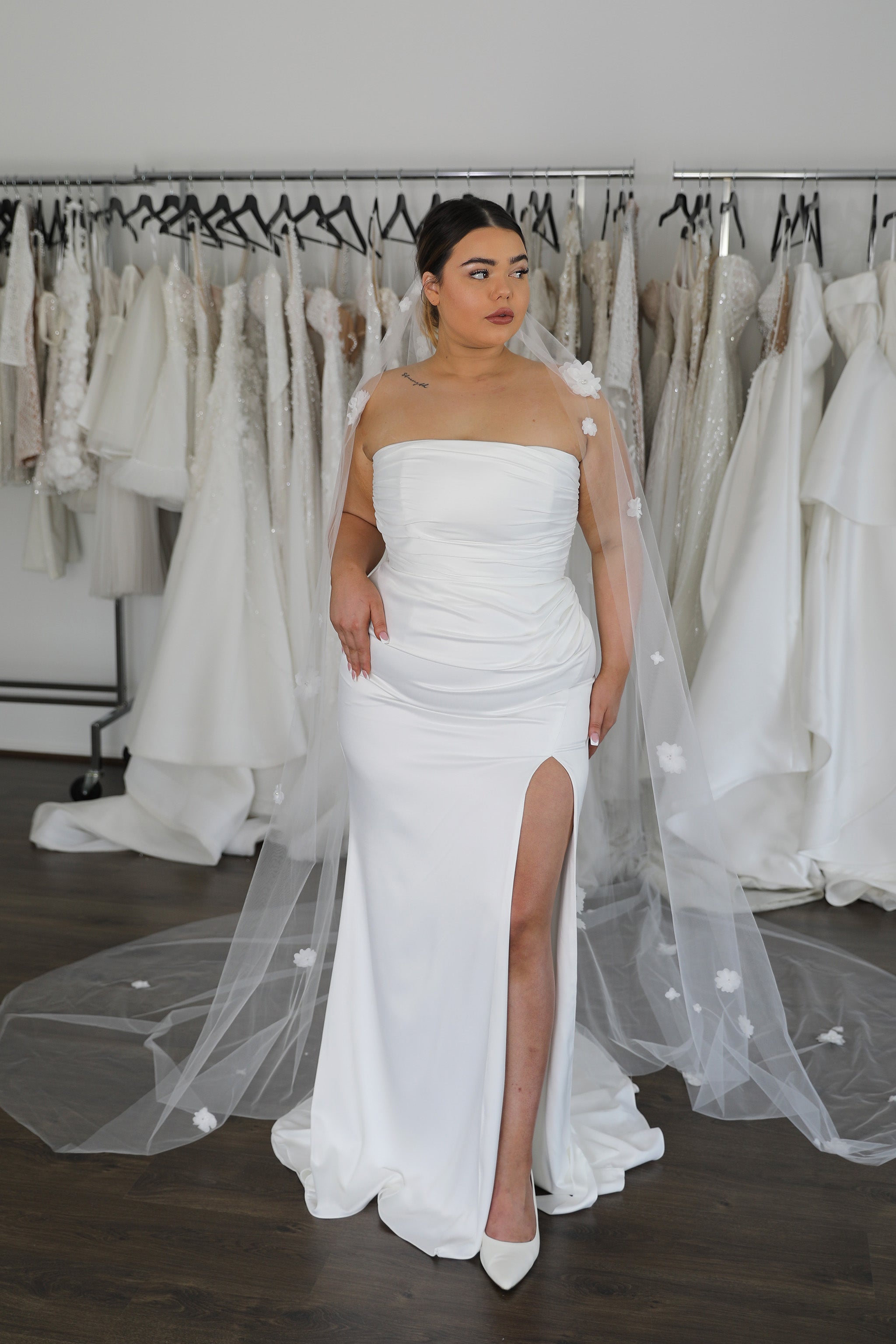 white strapless dress with thigh high split and floral veil