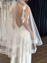 white tulle veil on bride wearing wedding slip dress
