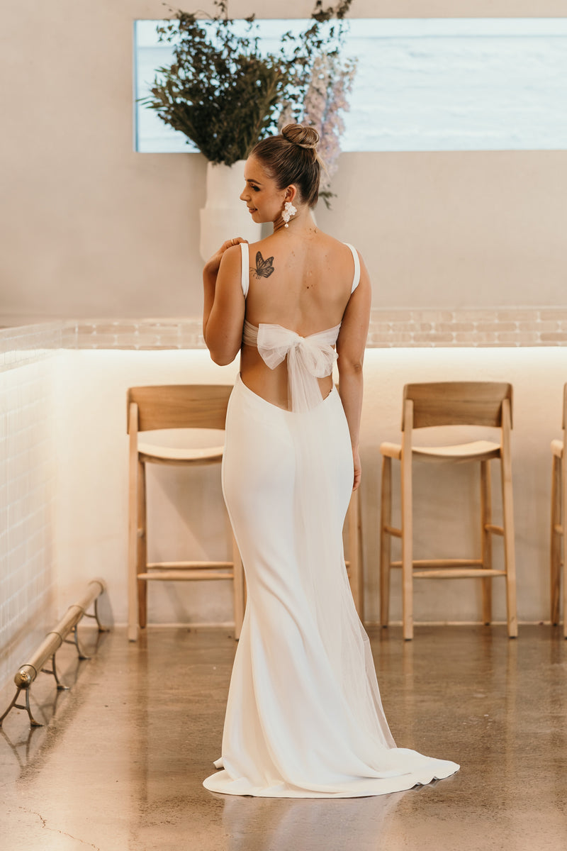 white wedding gown with tie back bow and thin shoulder straps
